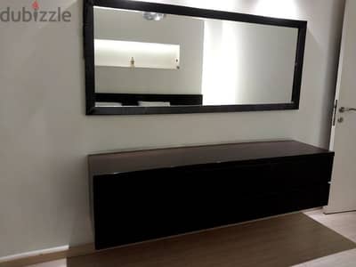 bedroom with bed side table and dressing table with mirror