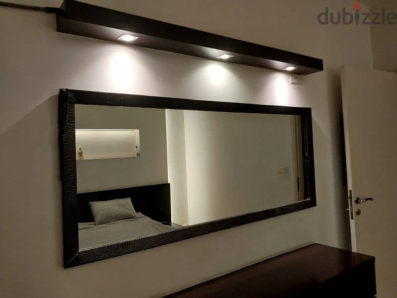 bedroom with bed side table and dressing table with mirror 1