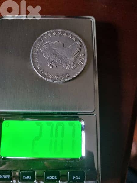A silver old coin 7 dollars the gram 7