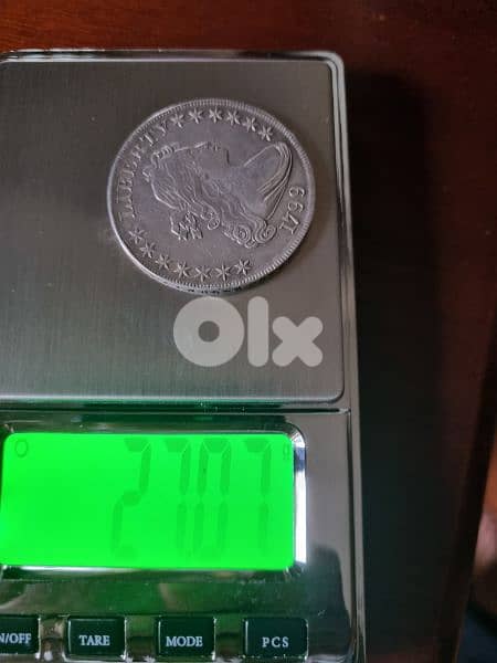 A silver old coin 7 dollars the gram 8