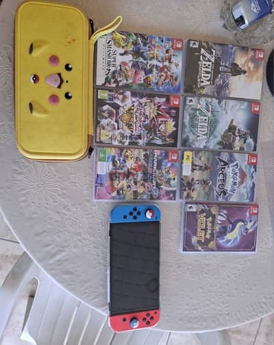 nintendo switch Oled + 7 games + Case & Charger