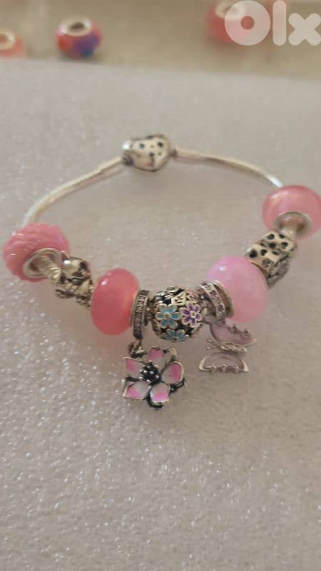 Pandora like silver bracelet with silver charms. 0