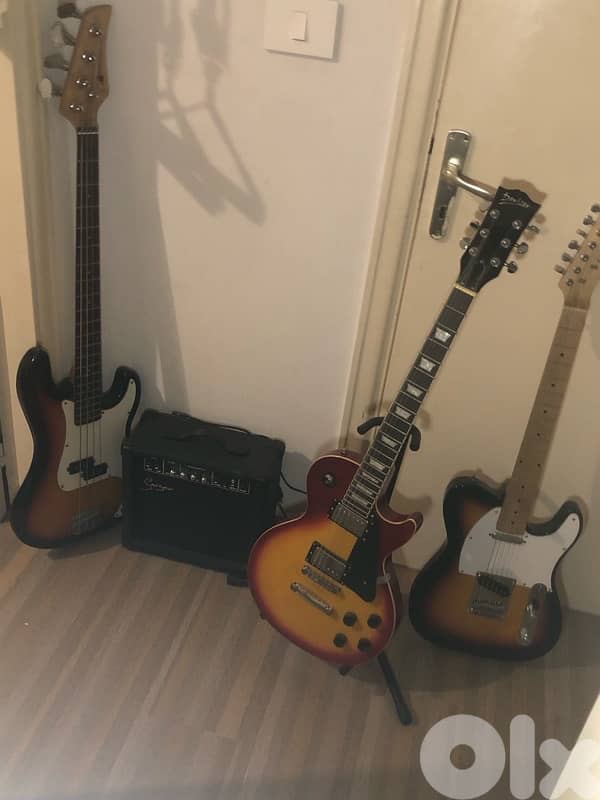 2 guitars one bass one amplifier 0