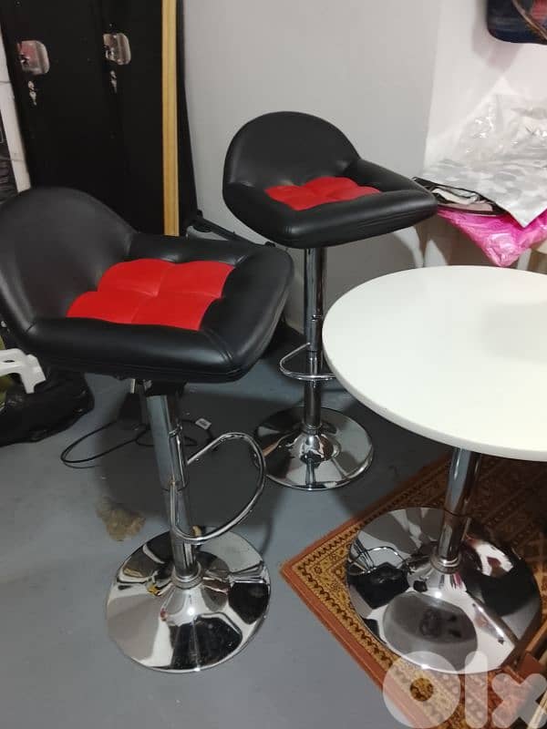 two chairs with a table 0