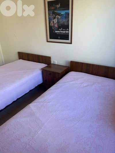2 single beds + 2 mattresses + nightstand in good condition