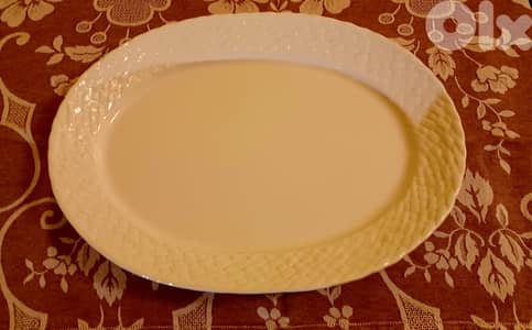 White ceramic serving platter with basket-weave rim