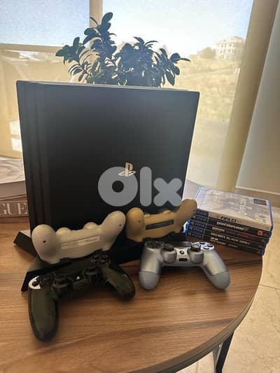 Playstation 4 Pro with 4 original controllers, 5 video games, bag