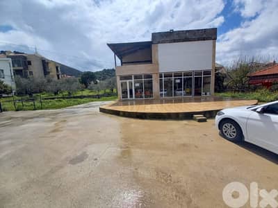 Land with building on Arz highway for rent.