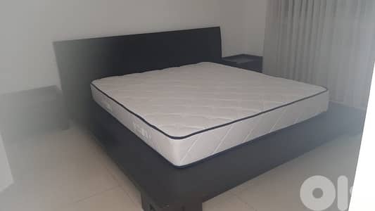 big bed with 2 night tables