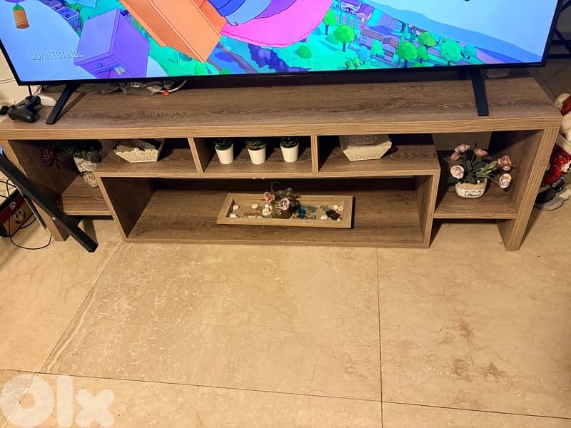 living room with 2 tables and a tv stand 0