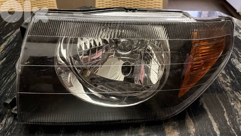 headlight Pajero io 0
