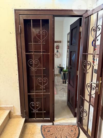 Mogono wood entrance door with safety door
