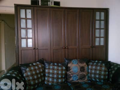 Closet along side 2 beds and a set of couches all good condition