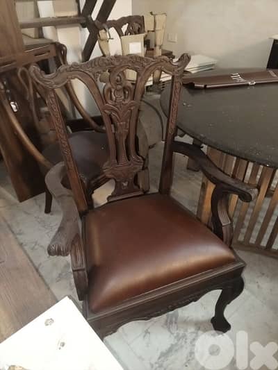 teak wood and leather armchairs