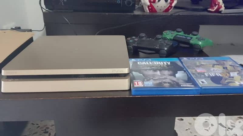 PS4 slim gold used 2 controllers and games good condition 1