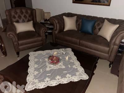 living room 3 sofas and a center table