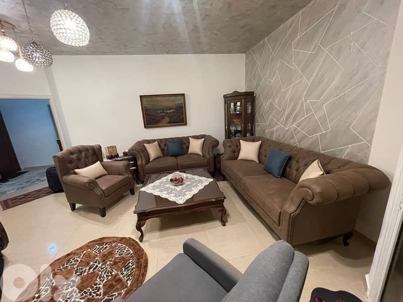 living room 3 sofas and a center table 1