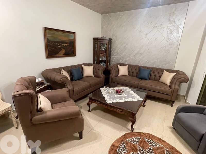 living room 3 sofas and a center table 2