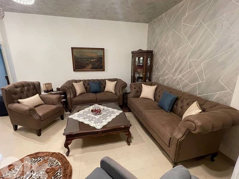 living room 3 sofas and a center table 3