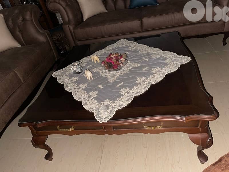 living room 3 sofas and a center table 4