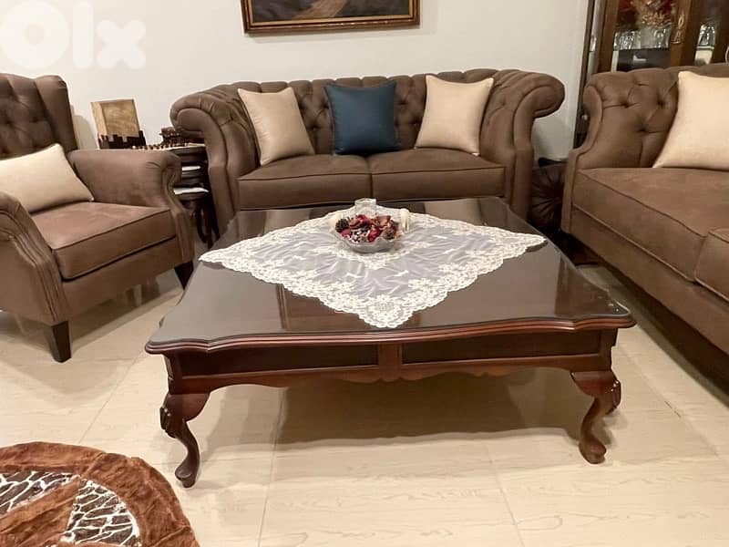 living room 3 sofas and a center table 5