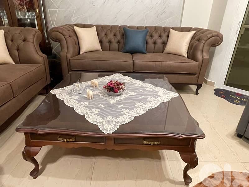 living room 3 sofas and a center table 6