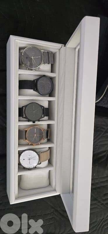 4 MVMT watches and 1 omorfia watch and box 1