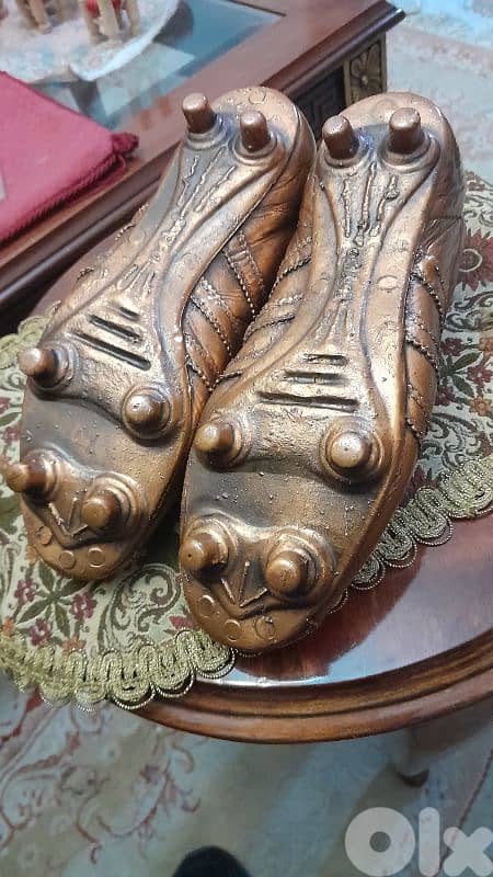 this is a cooper bronze football shoes (adidas) 1