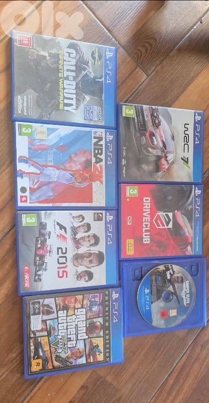 ps4 with 3 controllers and 7 games and steering wheel 6