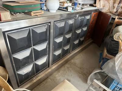 stainless black bar with one dining table base and glass board