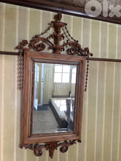 Mirror with a hand carved wooden frame