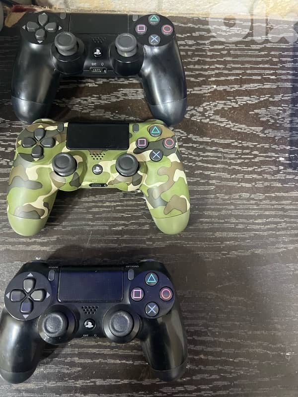 PS4 Pro with six cd and three controllers 2