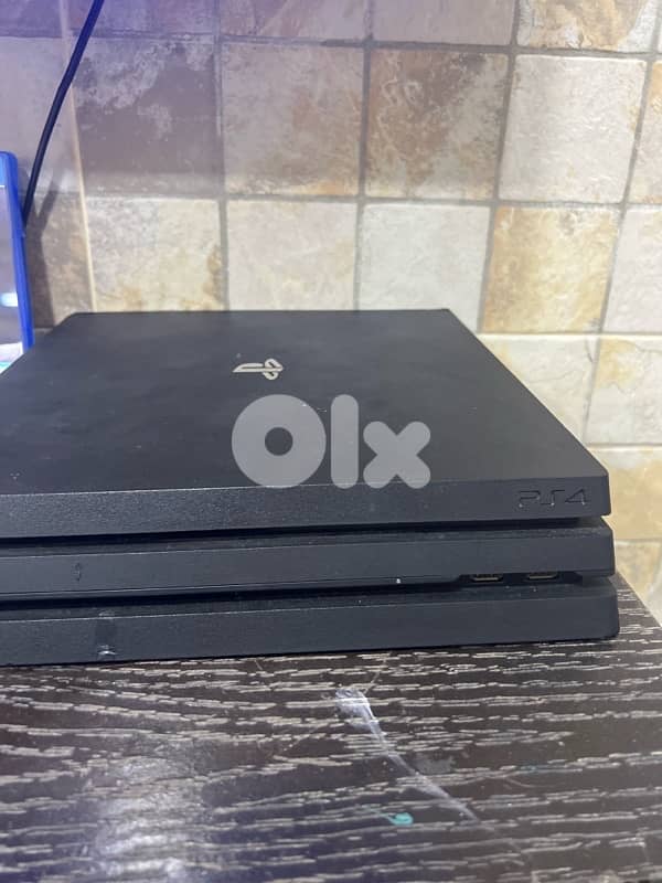 PS4 Pro with six cd and three controllers 3