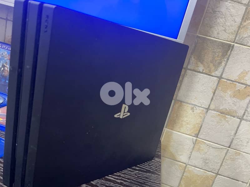 PS4 Pro with six cd and three controllers 4