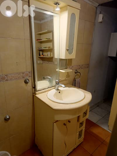 Bathroom sink with drawers and mirror