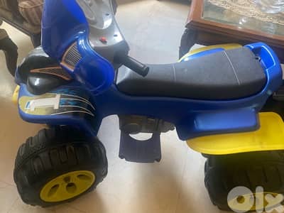 Kids ride-on toy car in blue and yellow with large wheels.