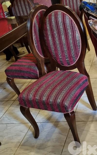 Wooden dining table with 6 wooden chairs.