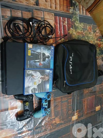ps4 slim 850 gb with 2 games and 2 controllers and bag