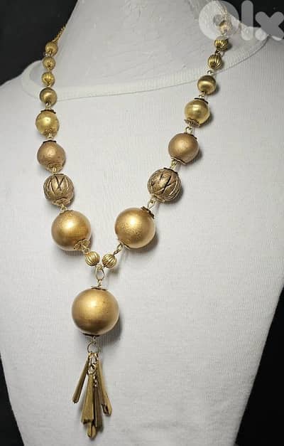 10$ gold-tone statement necklace with brass bead