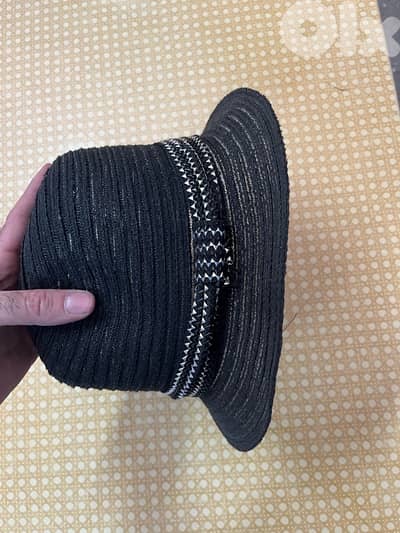 black braided cloche-style woman’s hat