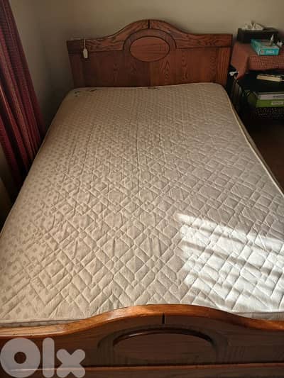 real wooden bed with mattress