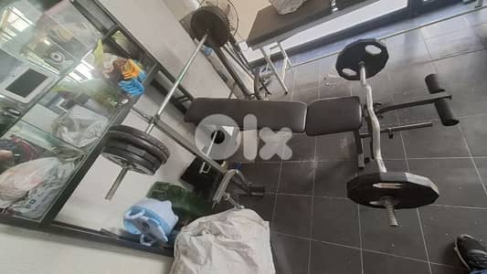 bench plus ajustable bench ,dumbells,and axes. . .