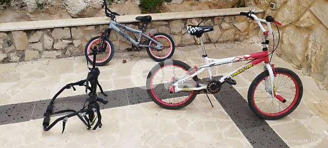 two bicycles and one stand for car