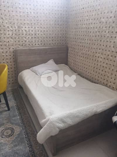 two beds with big dining table and 2 chairs