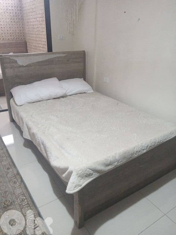 two beds with big dining table and 2 chairs 1