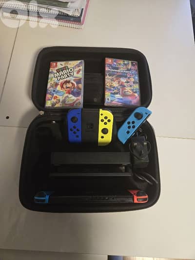 nintendo switch + 5 controllers + mario party game and mariokart 8
