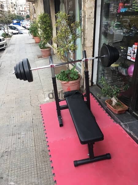 bench adjustable with adjustable rack with axe and weights all new 1