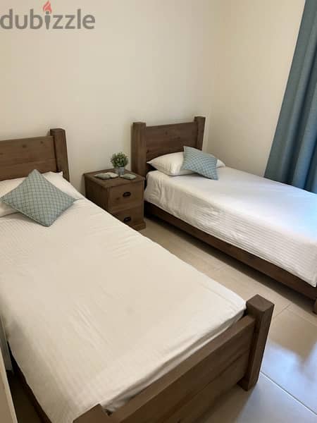 bedroom two besds with a bedside table and matresses never been used 1