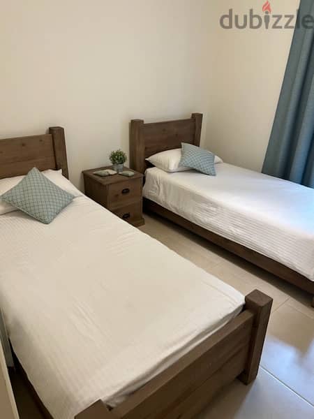 bedroom two besds with a bedside table and matresses never been used 2